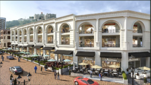 White neoclassical shopping arcade with arches, balconies, and outdoor cafes along a brick-paved street.