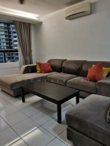 Grey L-shaped sofa with red and yellow cushions, a black coffee table, white tiled floor, large window with brown curtains, and a wall-mounted air conditioner.