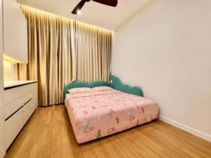 Child's bedroom with a pink animal-print bedspread, teal cloud headboard, and beige floor-length curtains.