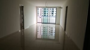 Empty living room with white walls and a high-gloss tiled floor, large sliding doors to a balcony letting in daylight, unfinished ceiling wires visible.