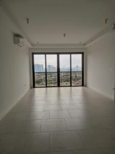 Empty, minimalist living room with large glass doors opening to a city skyline view eyewarning urban landscape outside.