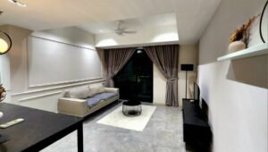 Modern living room with beige sofa, round black coffee table, and draped balcony doors framed by gray curtains.